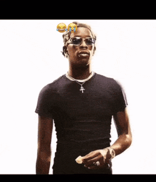 a man wearing sunglasses and a black shirt has a cross necklace
