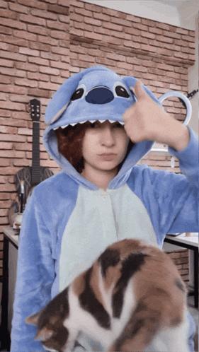 a girl wearing a stitch costume giving a thumbs up
