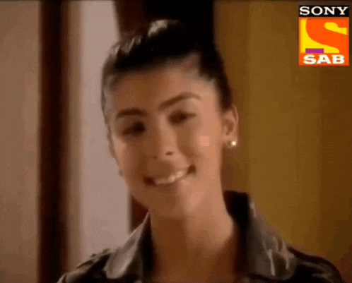 a close up of a woman 's face with a sony sab logo in the corner