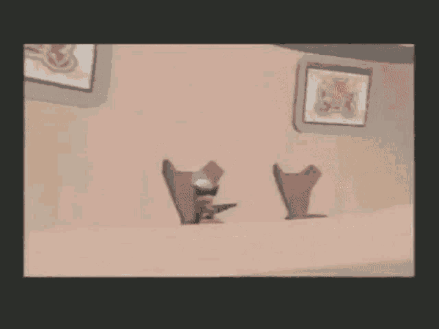 a cartoon character is sitting in a chair with a gun in his hand .