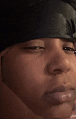 a close up of a woman 's face with a black headband on