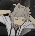 a man with a cat ear on his head is being held by another man .