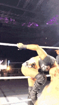 a man in a wrestling ring with a sticker on his shirt that says ' i love you ' on it