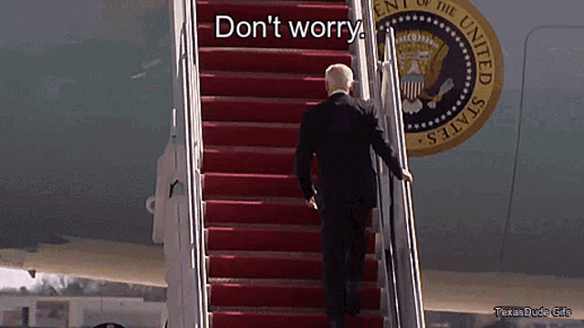 a man walking up a set of stairs with the words " do n't worry " written on it