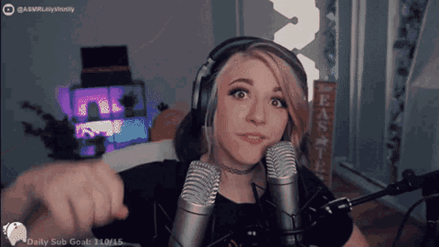 a woman wearing headphones stands in front of two microphones with a daily sub goal of 110/15 on the bottom