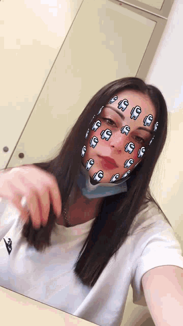 a girl wearing a mask with among us stickers on her face