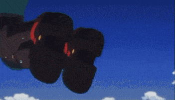 a red object is floating in the air with a blue sky behind it