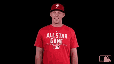 a man wearing a red shirt that says all star game is smiling
