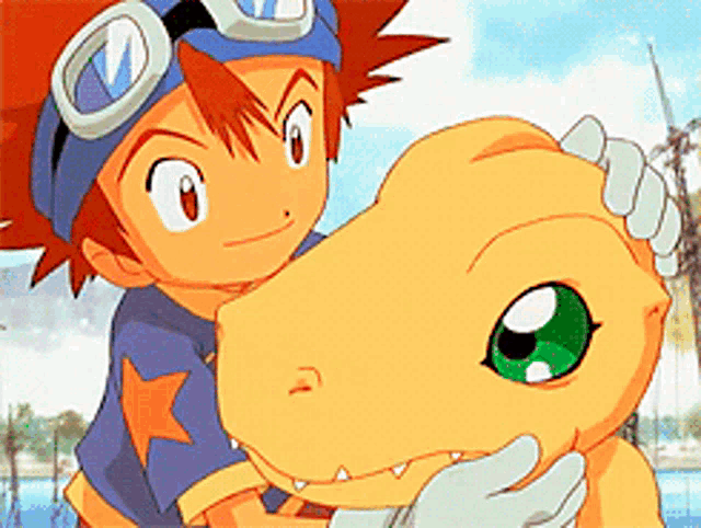 a boy in a blue shirt is petting a dinosaur .