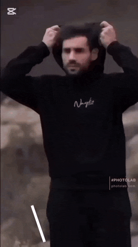 a man wearing a black hoodie that says kol