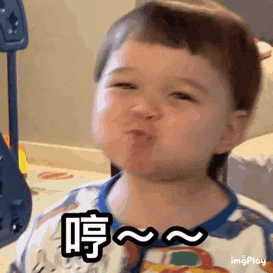 a baby is making a funny face and making a funny face with his mouth open .