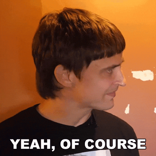 a man wearing a black shirt with the words yeah of course below him