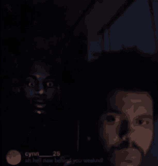 a man with a beard is standing next to another man with a black face