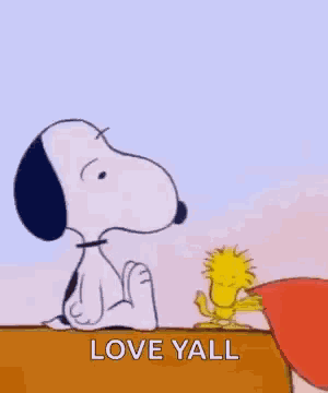 snoopy and woodstock are holding a heart in their mouths and saying `` love yall '' .