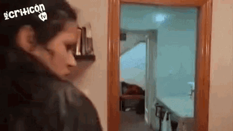 a woman is standing in front of a door in a living room .