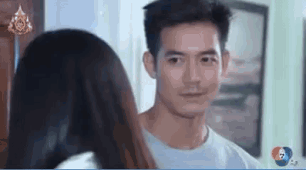 a man and a woman are standing next to each other in a room .
