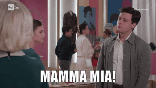 a man stands in front of a woman with the words mamma mia on the screen