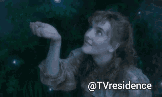 a woman in a plaid shirt is holding a star in her hand with the words @tvresidence above her