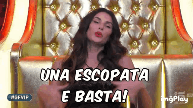a woman sitting in a chair with the words una escopata e basta written above her