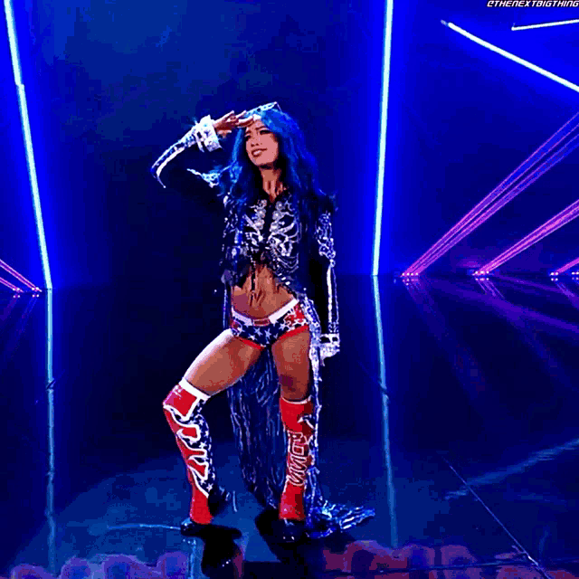 a female wrestler is standing in front of a crowd with the hashtag #thenextbigthing written on the bottom