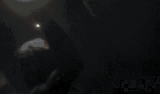 a blurred image of a person standing in the dark