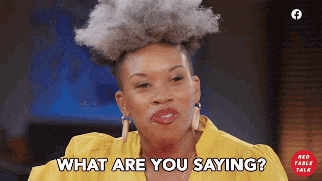 a woman says what are you saying in a yellow shirt