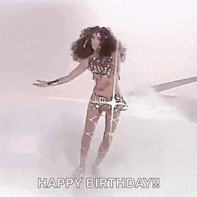a woman with long hair is wearing a costume and a crown and is saying happy birthday .