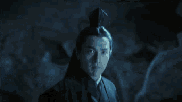 a sword is being thrown in the air in a dark room