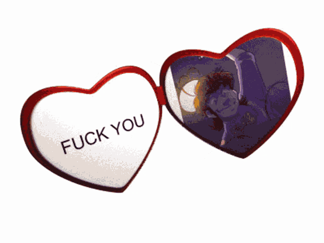 a heart shaped mirror with a picture of a man and the words " fuck you " on it