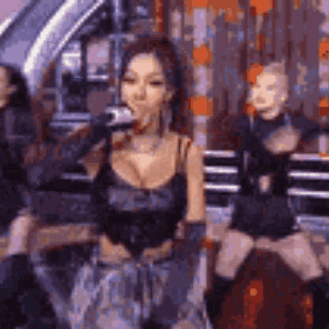 a woman is singing into a microphone on a stage while dancing .