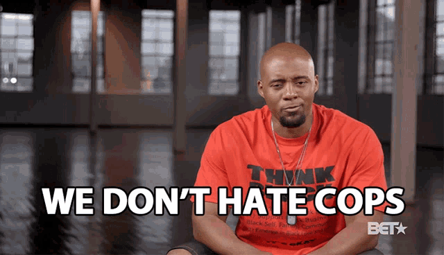 a man is wearing a red shirt that says think on it