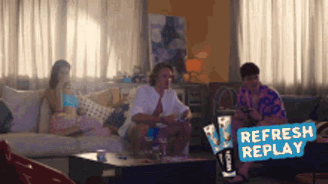 a group of people are sitting on a couch in a living room with a sign that says " refresh replay "