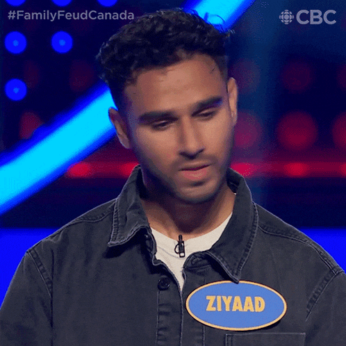 a man wearing a jacket with a name tag that says ziyaad