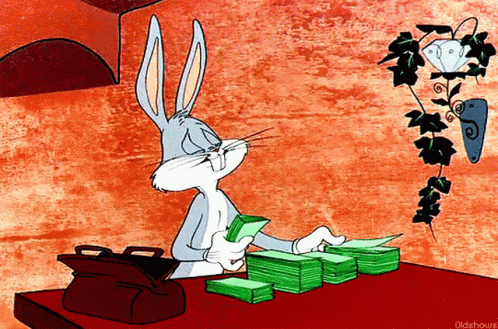 a cartoon of bugs bunny sitting at a table with stacks of money