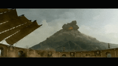 a volcano is erupting in the distance behind a building