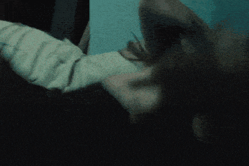 a woman in a white tank top is laying on her back