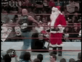 a man in a santa suit is standing in a ring