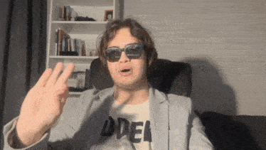 a man wearing sunglasses and a t-shirt that says odel