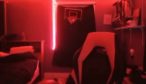 a bedroom with a basketball hoop hanging on the wall and a chair in the foreground .