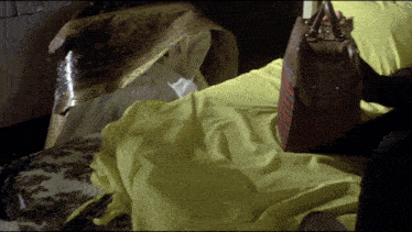 a person laying on a bed with a briefcase on the bed