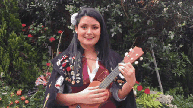 a woman with a flower in her hair is holding an ukulele