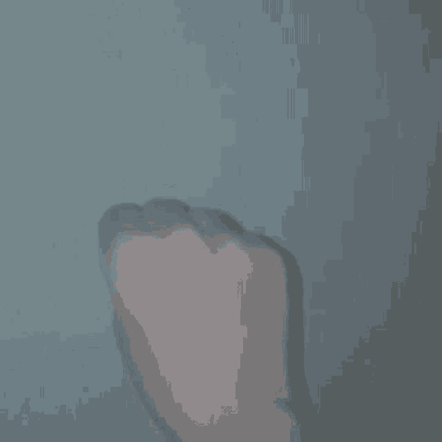 a close up of a person 's fist against a white wall .