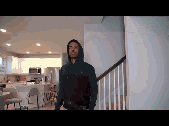 a man in a hoodie with the word tommy on the front