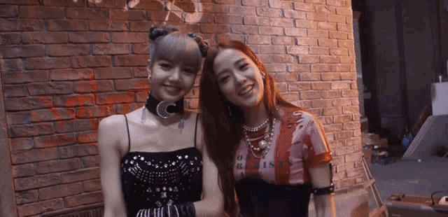 two women standing next to each other with one wearing a shirt that says ' oasis '
