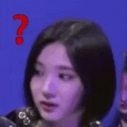 a woman with short black hair is making a funny face with a question mark .