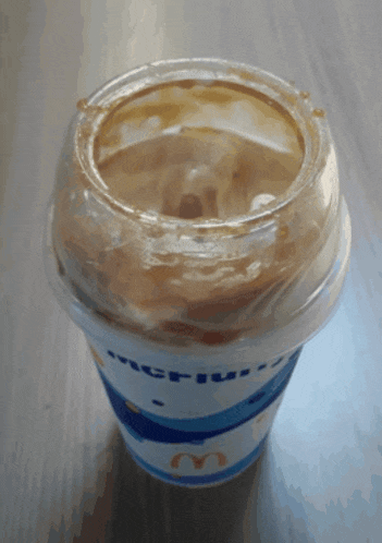 a mcdonald 's cup with a plastic lid on it
