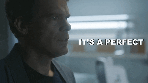 a man in a suit says " it 's a perfect " in a dark room