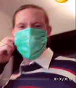 a man is wearing a green face mask and a striped shirt