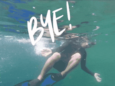 a man is swimming in the ocean and the word bye is written on the water