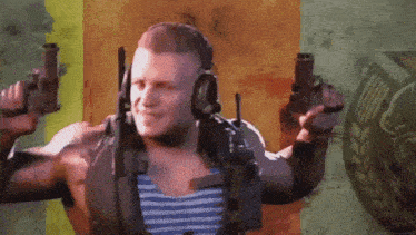 a man wearing headphones and holding two guns